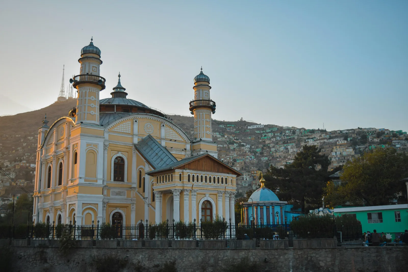 Large mosque beside a hillside city.