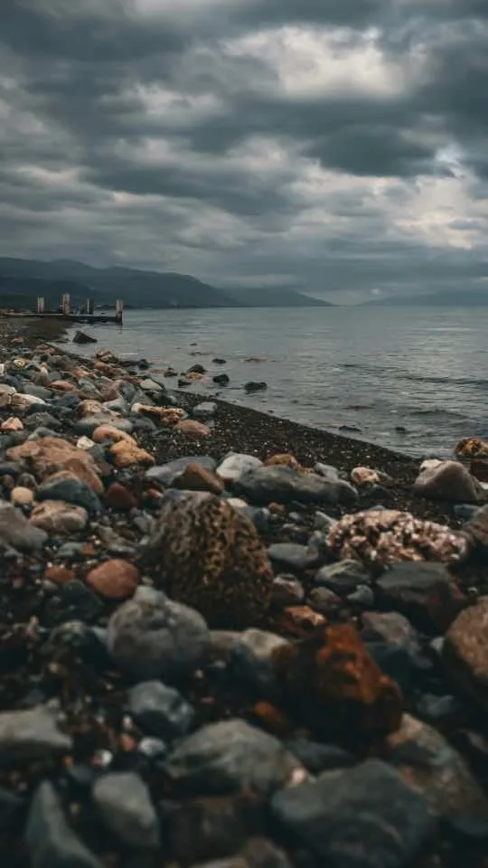 Rocky shoreline beneath a cloudy sky.